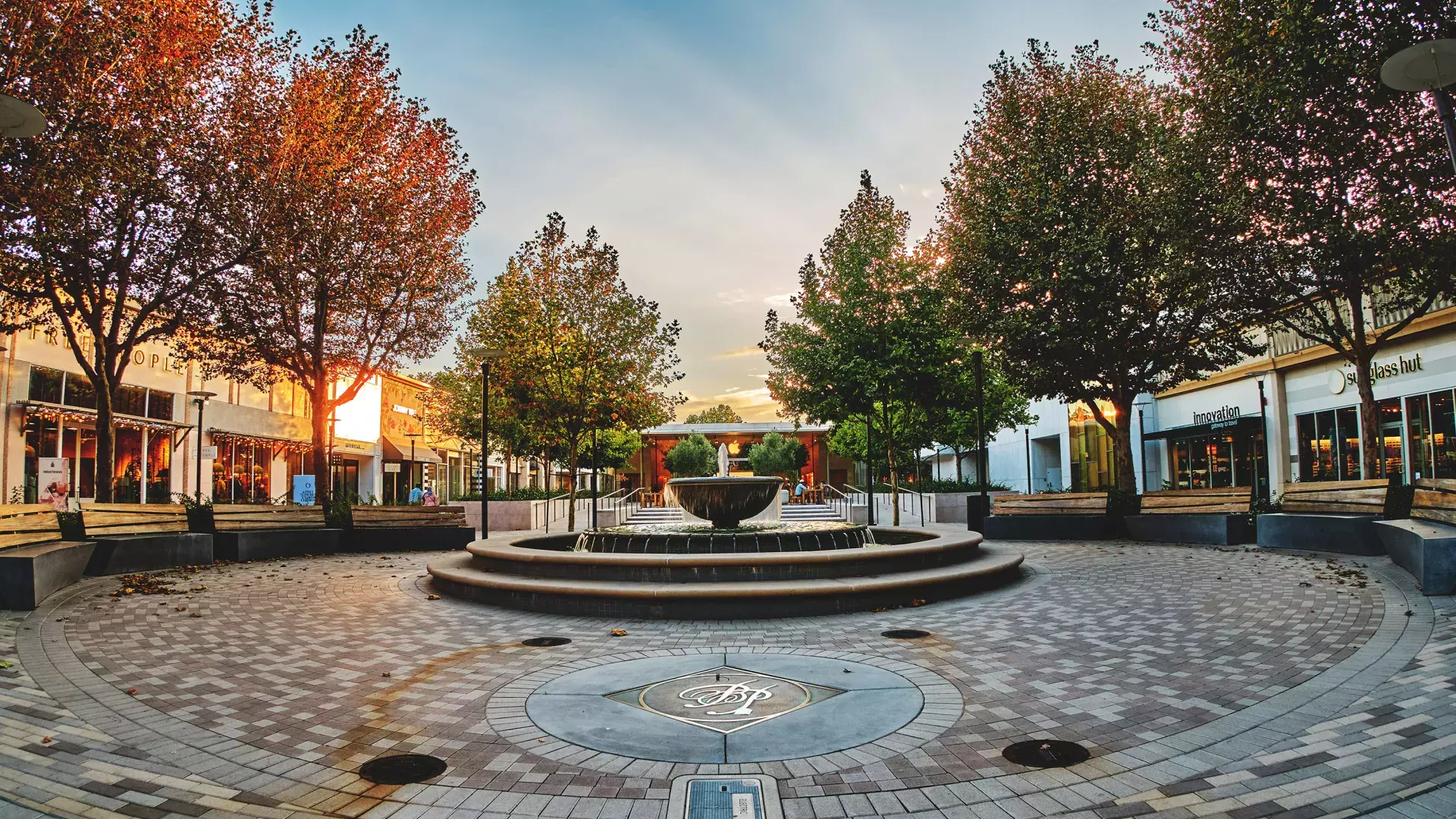Outdoor mall with trees and fountain